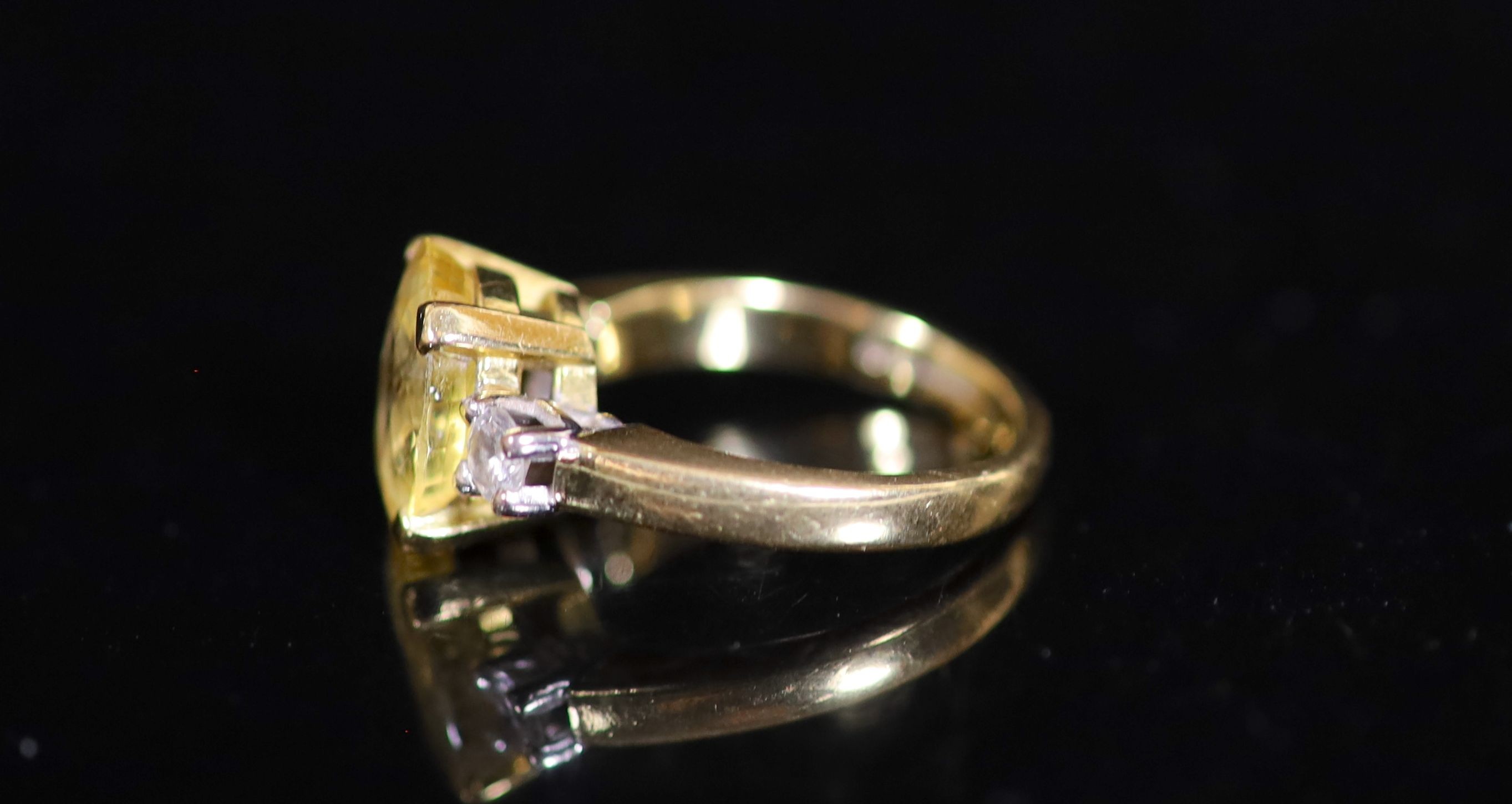 An 18ct gold, yellow sapphire and diamond set three stone ring